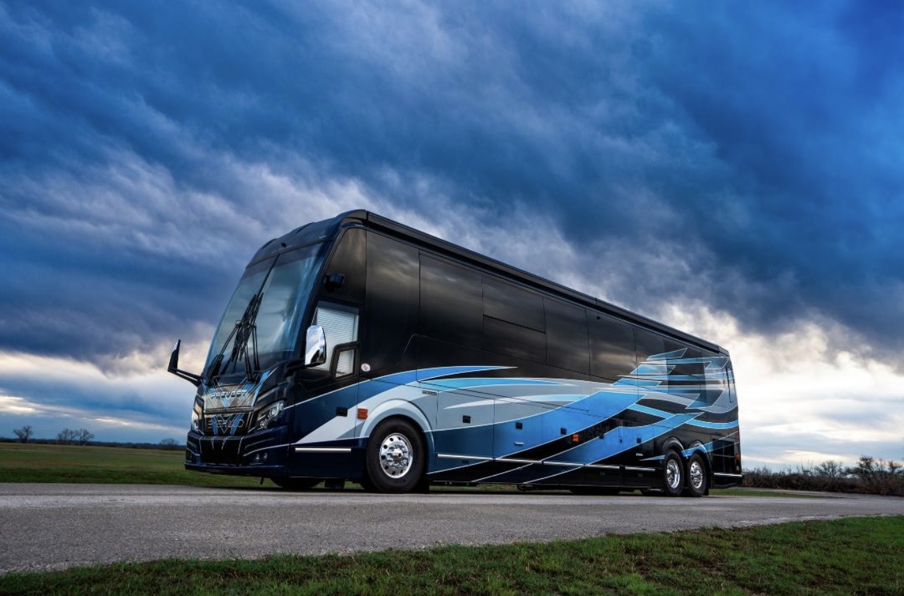 Luxury motorcoach against a dramatic sky on Vanturis